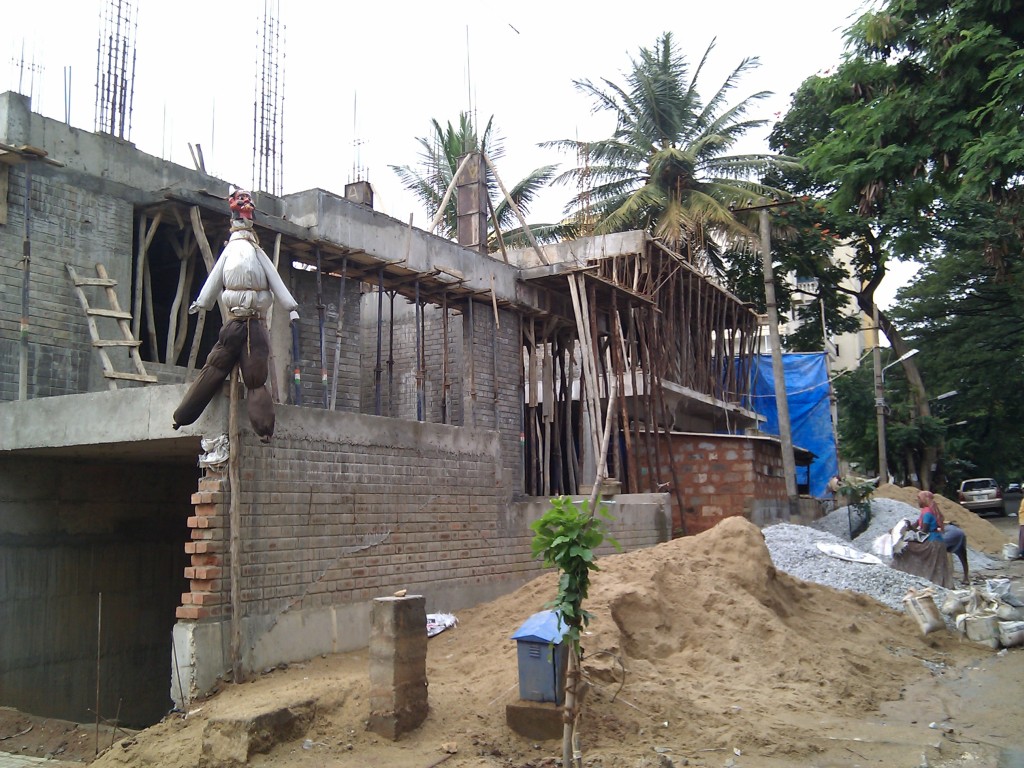 Brick and concrete work in progress behind scaffolding on a building site
